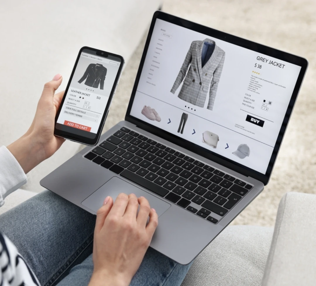 Web developer checking mobile and desktop interface of an ecommerce website