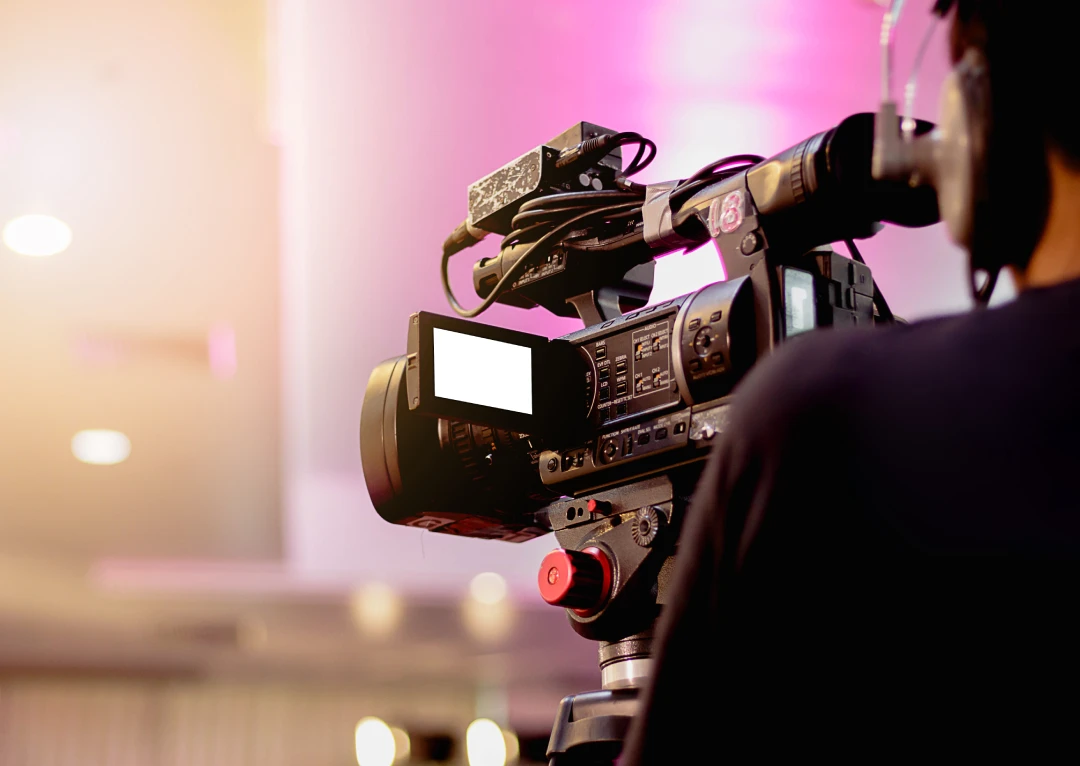 A man shooting a video from a professional video recording camera